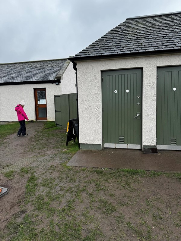 Example muddy grassy paths. Picture of toilet access and door back to visitor reception.