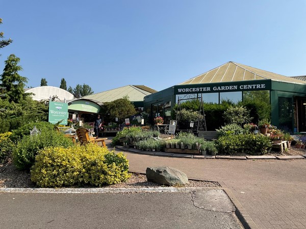 Image of a garden centre with plants and a sign