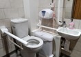 Accessible toilet with handrails and sani-bin. The soap is full and it is nice and clean.