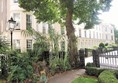 The small gardens in front of the row of houses are part of the College's gardens