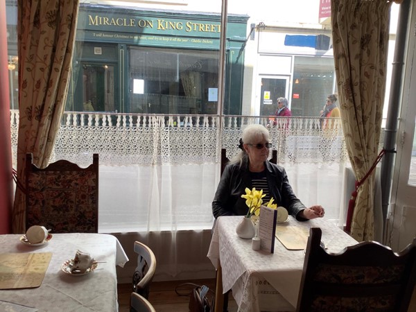 Picture of a person at a table in a cafe