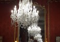 Picture of a chandelier in front of a mirror