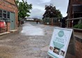 Picture of a road between red brick buildings