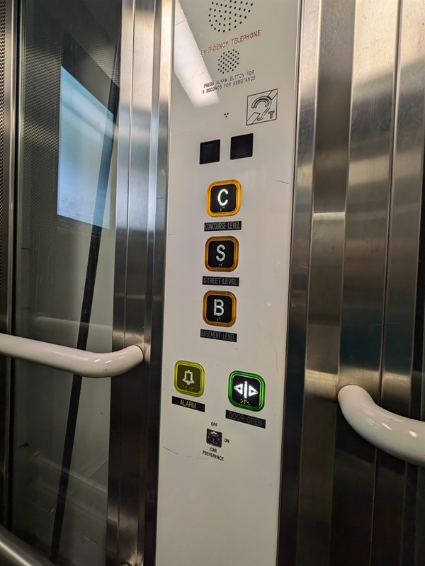 Image of lift. The lift buttons have Braille Markings