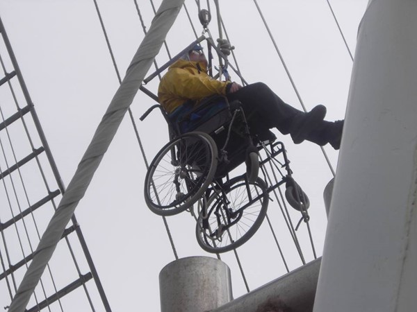 A wheelchair user climbing the mast.