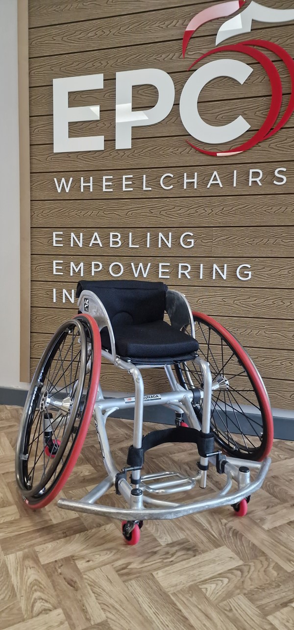 Image of a wheelchair with a sign in the background