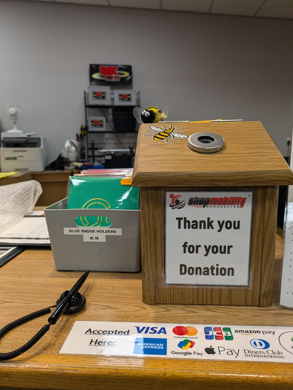 Image of donation box and blue badge holders