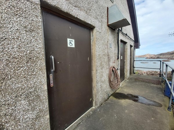 Image of the door of the accessible toilet in the next image.