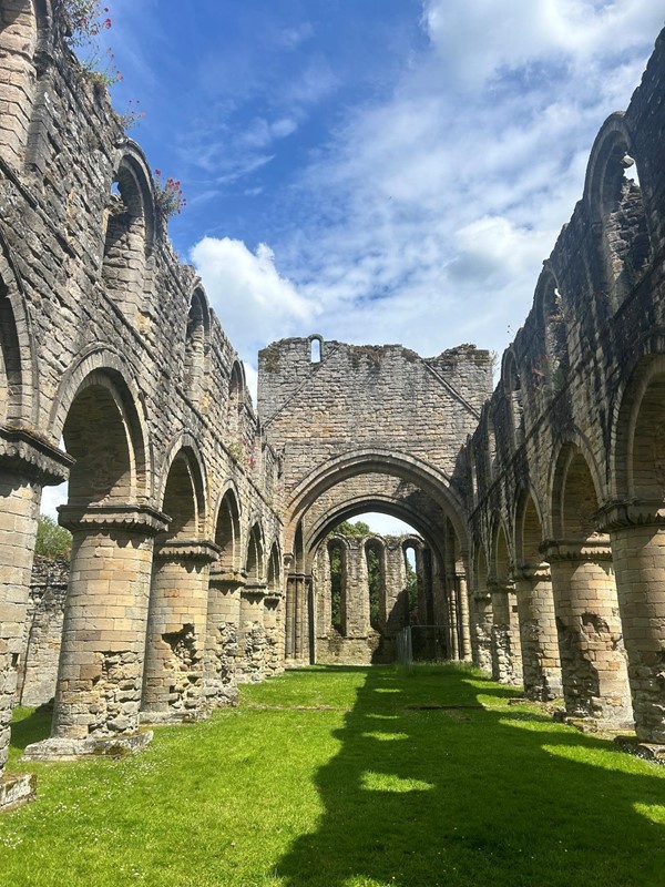 Image of a stone archway with arches and arches in a grassy area