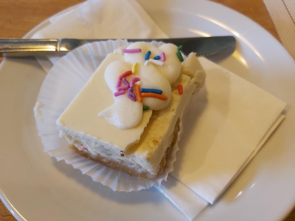 Image of a piece of cake with sprinkles on top