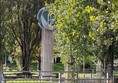 Image of a sign for the park, obscured by the trees