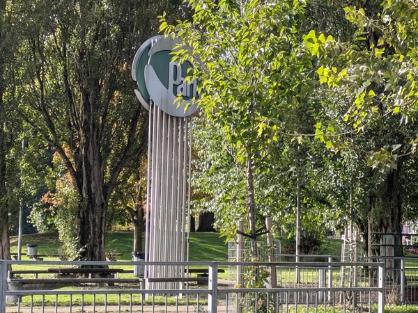 Image of a sign for the park, obscured by the trees