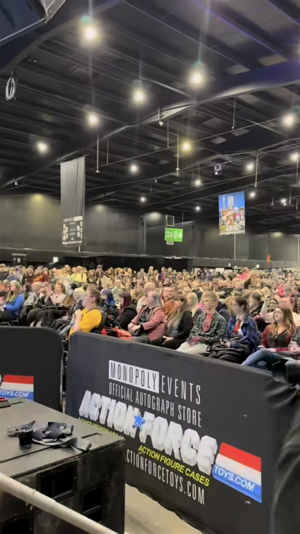 Image of a large group of people sitting in a large room