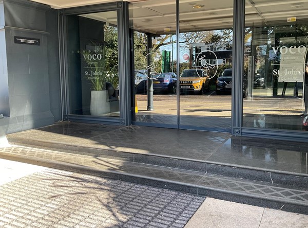 Two steps leading into hotel and automatic door