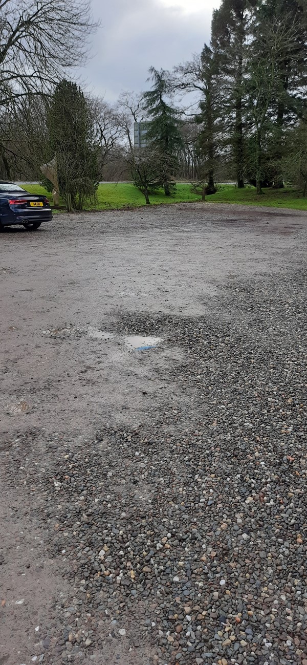 Potholes and gravel on the car park