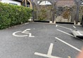 Image of a parking lot with a wheelchair sign