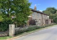 Image of a street with a brick building and a tree