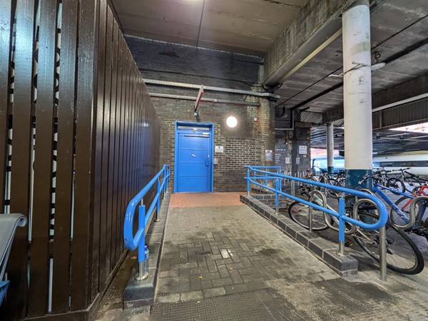 Image of entrance to the Changing Places toilet, a ramp with rails on either side