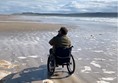 Image of a person in a wheelchair on a beach