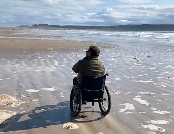 Image of a person in a wheelchair on a beach