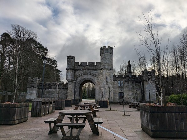 Image of picnic benches and Cairn Lodge gatehouse