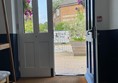 Image of a door with glass panels and a chair in front of a building