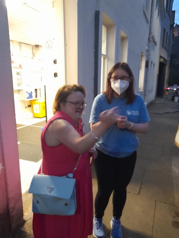 Two people standing in a street