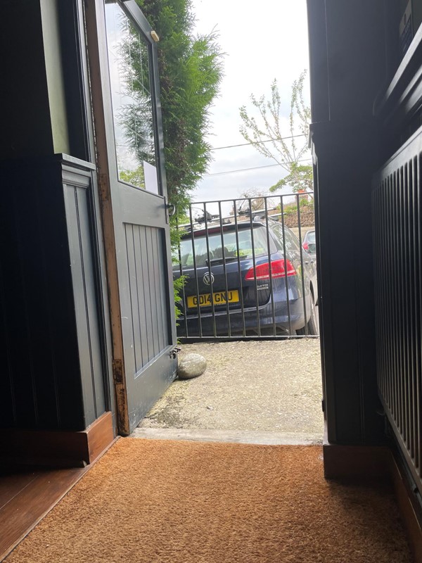 Image of a door and a car in the background