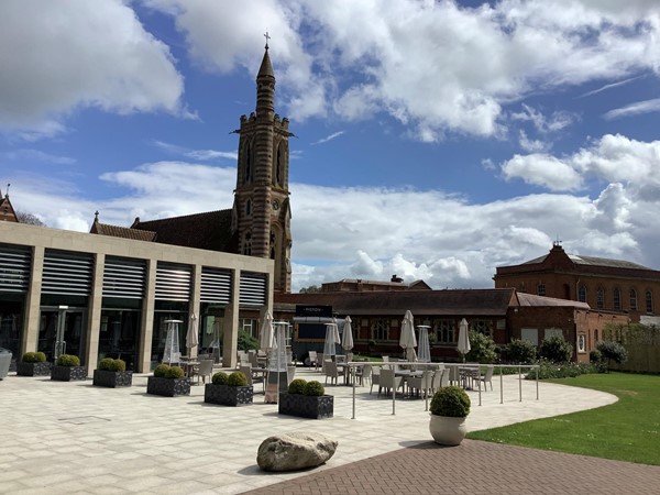 Picture of a patio with a church in the background