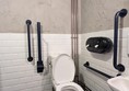 image of accessible toilet, and contrasting grab rails