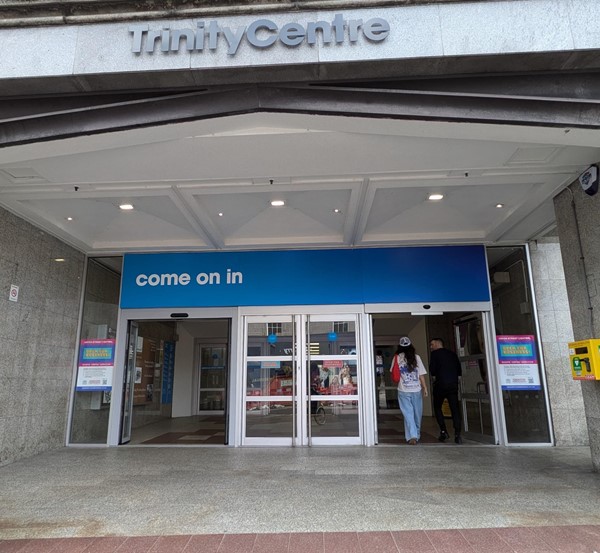 Image of the Union Street Entrance, a slight uneven slope. The words Trinity Centre appear above the entrance.