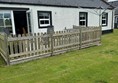 Image of a house with a fence.