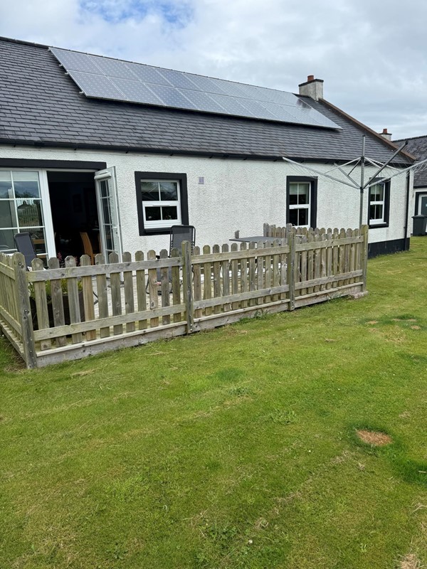 Image of a house with a fence.