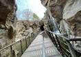 The suspended walkway through the rock gorge with its cascading waterfalls