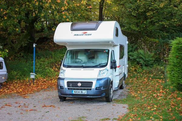 Motorhome pitched on one of three level(ish) pitches. All other pitches are on a slope, some quite significant.