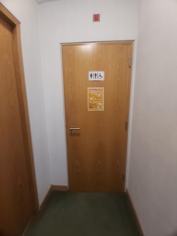 Image of an accessible toilet door in a room