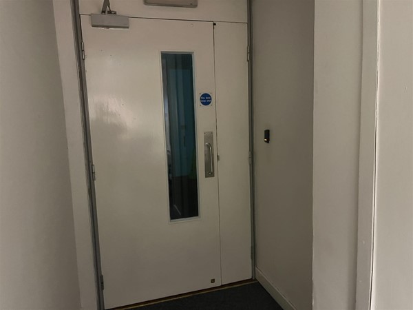 Heavy white fire exit door for secondary emergency exit.