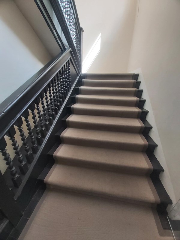 Image of a staircase with a black railing