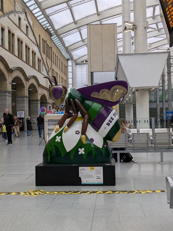 Image of a colourful bee statue in the railway station.