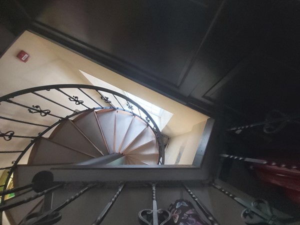 Image of a spiral staircase with a black railing