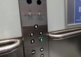 image of the lift buttons, they do not have Braille markings