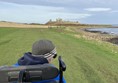 Image of a wheelchair user on a coastal path