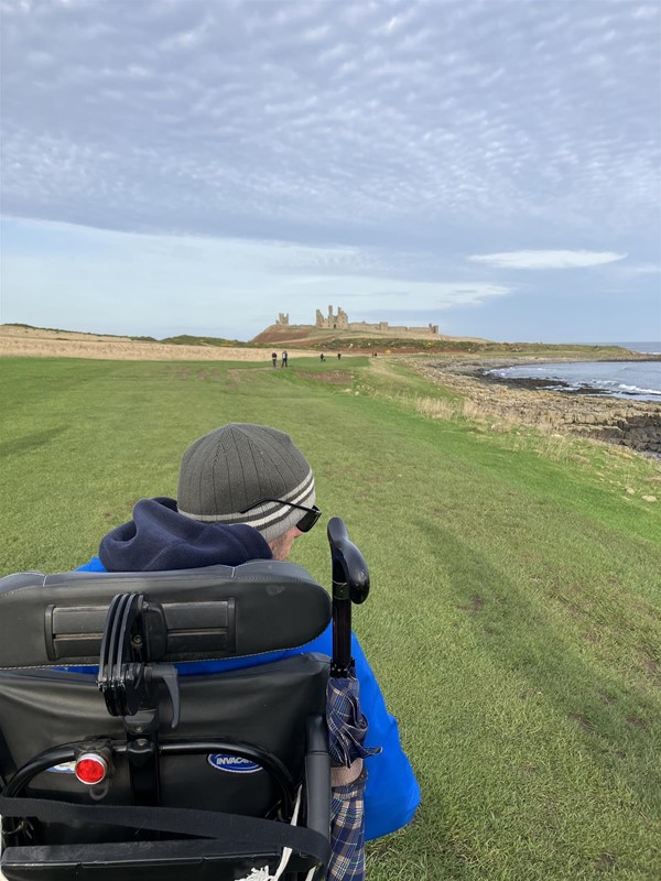 Image of a wheelchair user on a coastal path