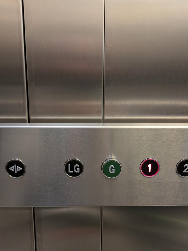 Image of buttons in lift. The lift buttons do not have Braille Markings