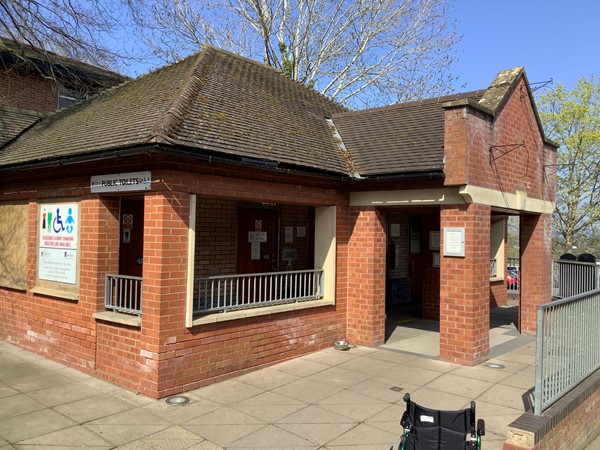 Picture of a red brick toilet building