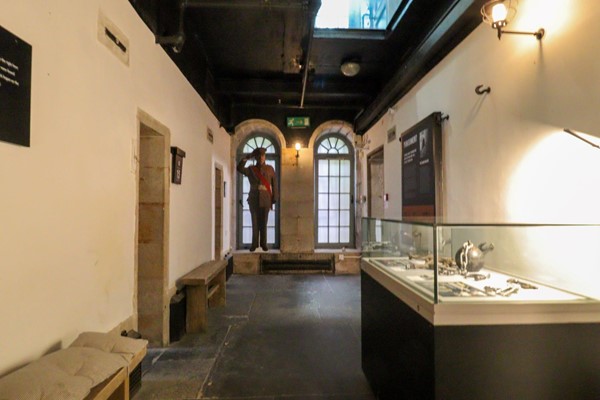 Corridor with museum display cases on the right.