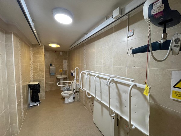 Image of a bathroom with a shower and a changing table