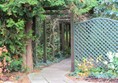 Entry to the secret garden on flagged path. Before this it is bark though.