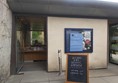 Ticket desk and chalk board saying "Welcome to the Botanic Garden"