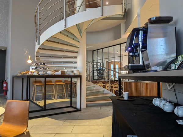 Image of a table with pastries and coffee machine